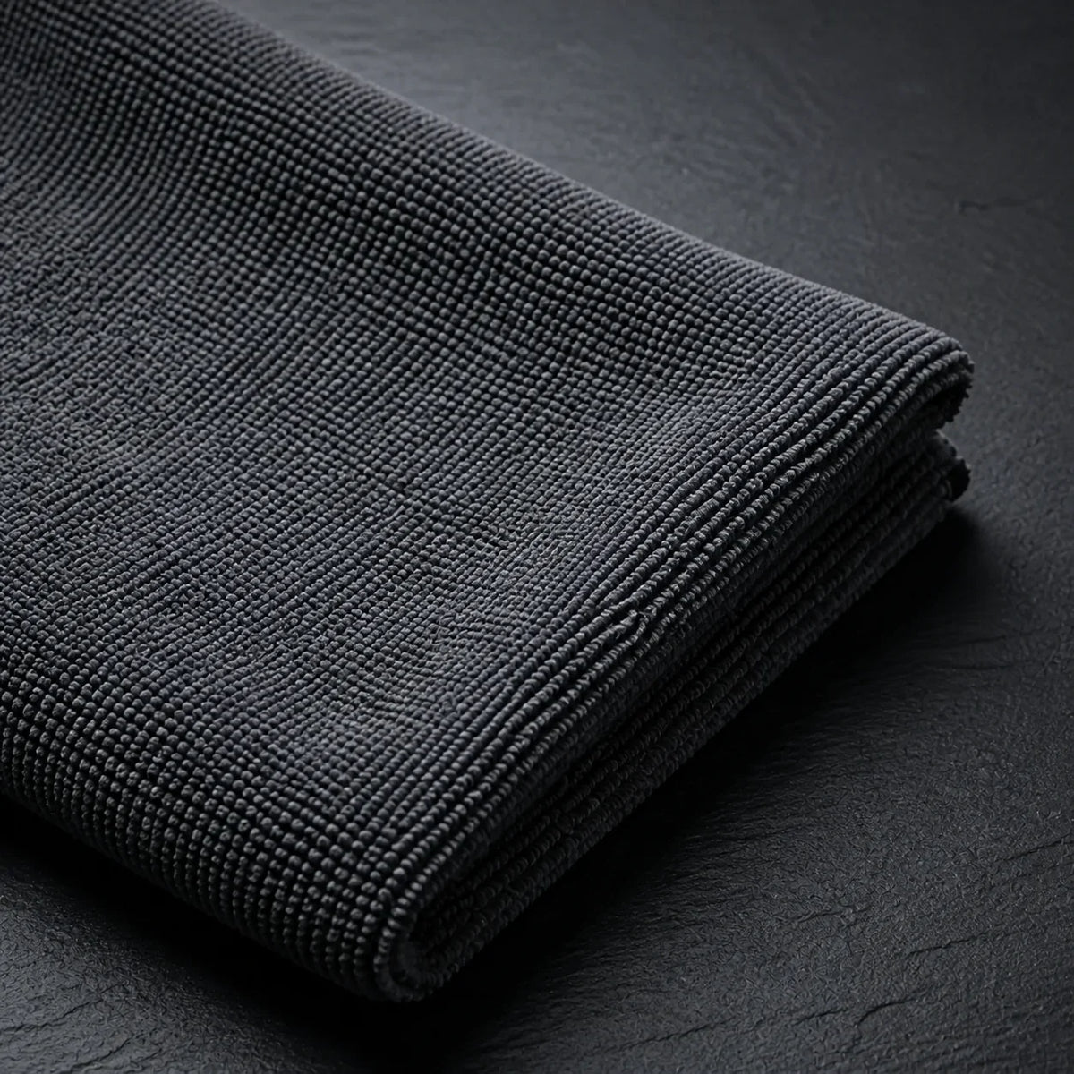 Macro view of the HexaGloss 300 GSM charcoal pearl-weave leveling towel