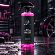 HexaGloss All-Purpose Cleaner with trigger sprayer in a professional automotive detailing studio
